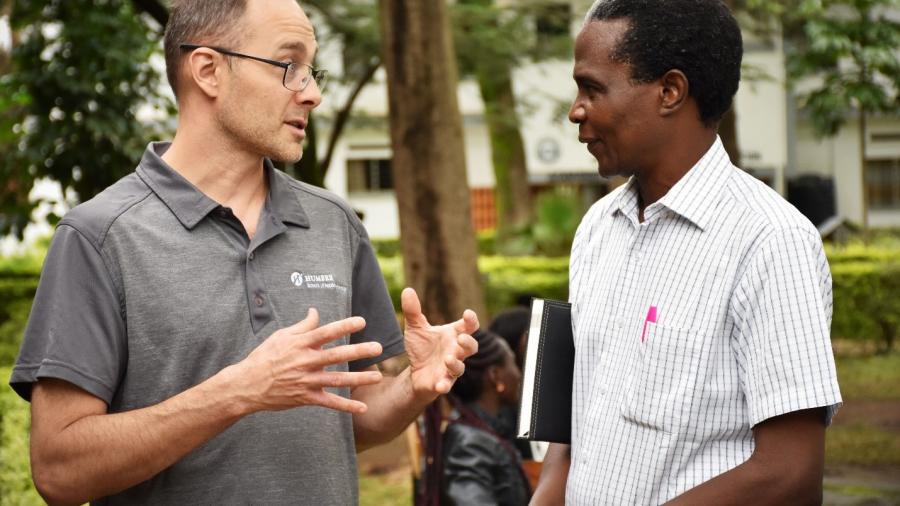 Shawn Cleary and Samson Obuya discussing the environmental scan results at Kisumu National Polytechnic