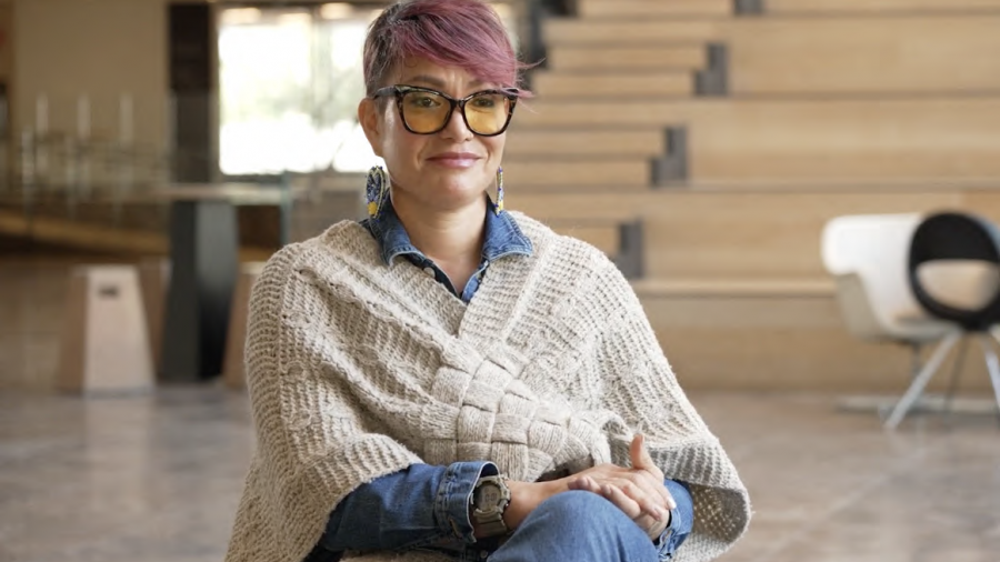 A person sits in a chair for an interview.