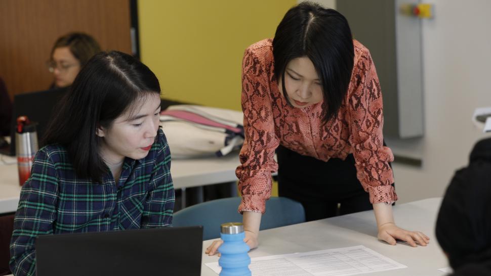 Io Qiu (right) consults with a classmate during the 2020 Siemens-Humber Hackathon