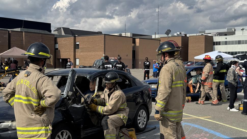 Rescue Day Group of first responders in training attend to a simulated car crash scene
