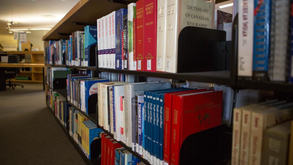 A library stack at Humber College holds rows and rows of colourful books.