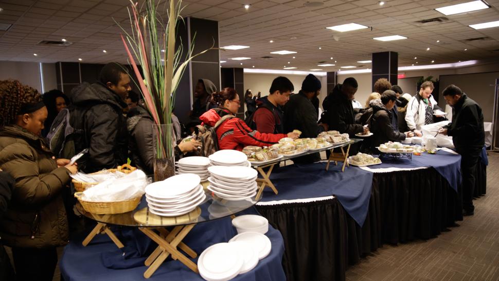 Humber College has released its Food Strategy and Vision that will help guide on-campus food offerings going forward. People line up to serve themselves food from a table while holding plates and cutlery.