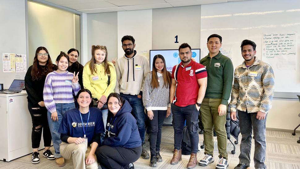 A team of Humber Polytechnic students won first place at the CICan National Skills for Success Hackathon. A group of smiling people stand together. Two people are wearing Humber Polytechnic apparel.