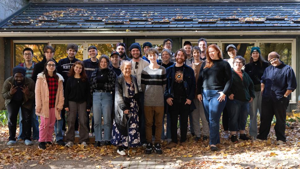 Students in the Film and Television Production program had their capstone projects receive a Green Seal for Students Certification from the Environmental Media Association. A group of people stand together in front of a house.