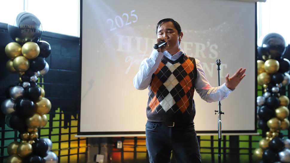 A person sings into a microphone.