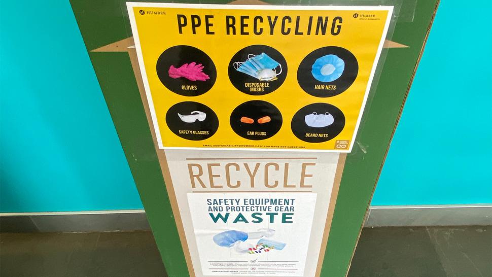 A box with a sign on it that has images of the items it accepts that reads PPE recycling.