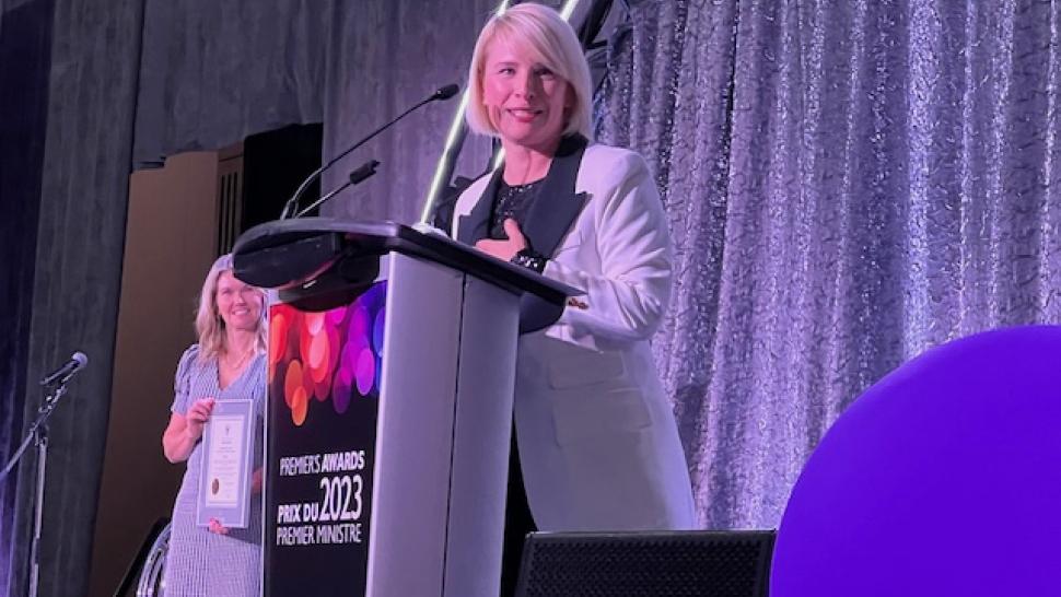 A person speaks while standing at a podium that reads Premier’s Awards 2023.