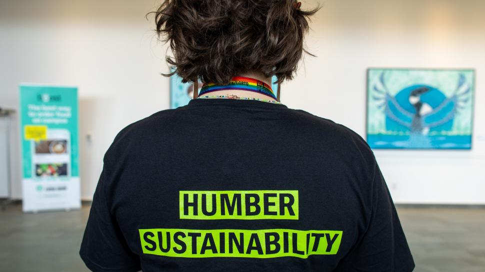 A person wearing a t-shirt that reads Humber Sustainability.