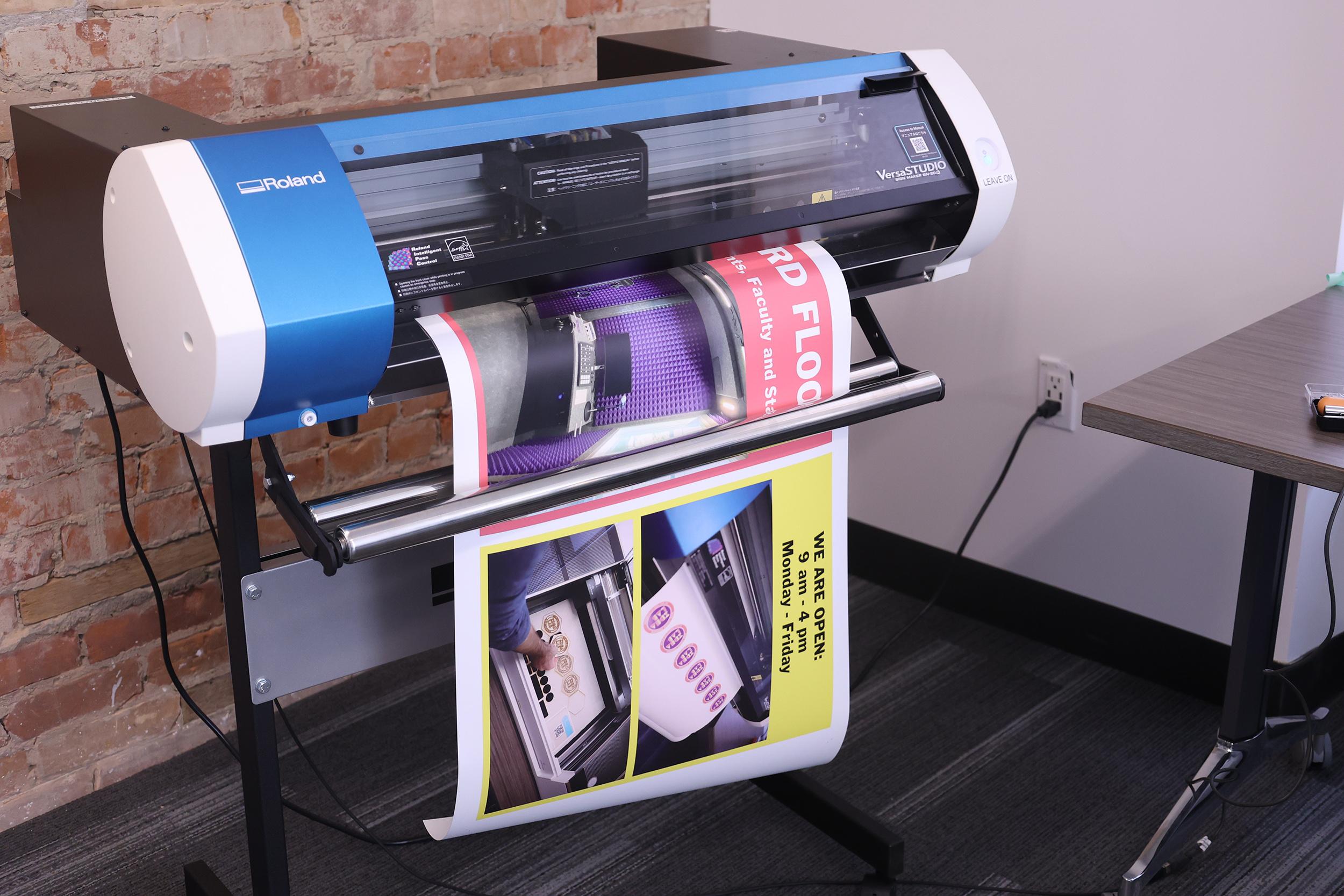 A colourful sign being printed by a large printer.