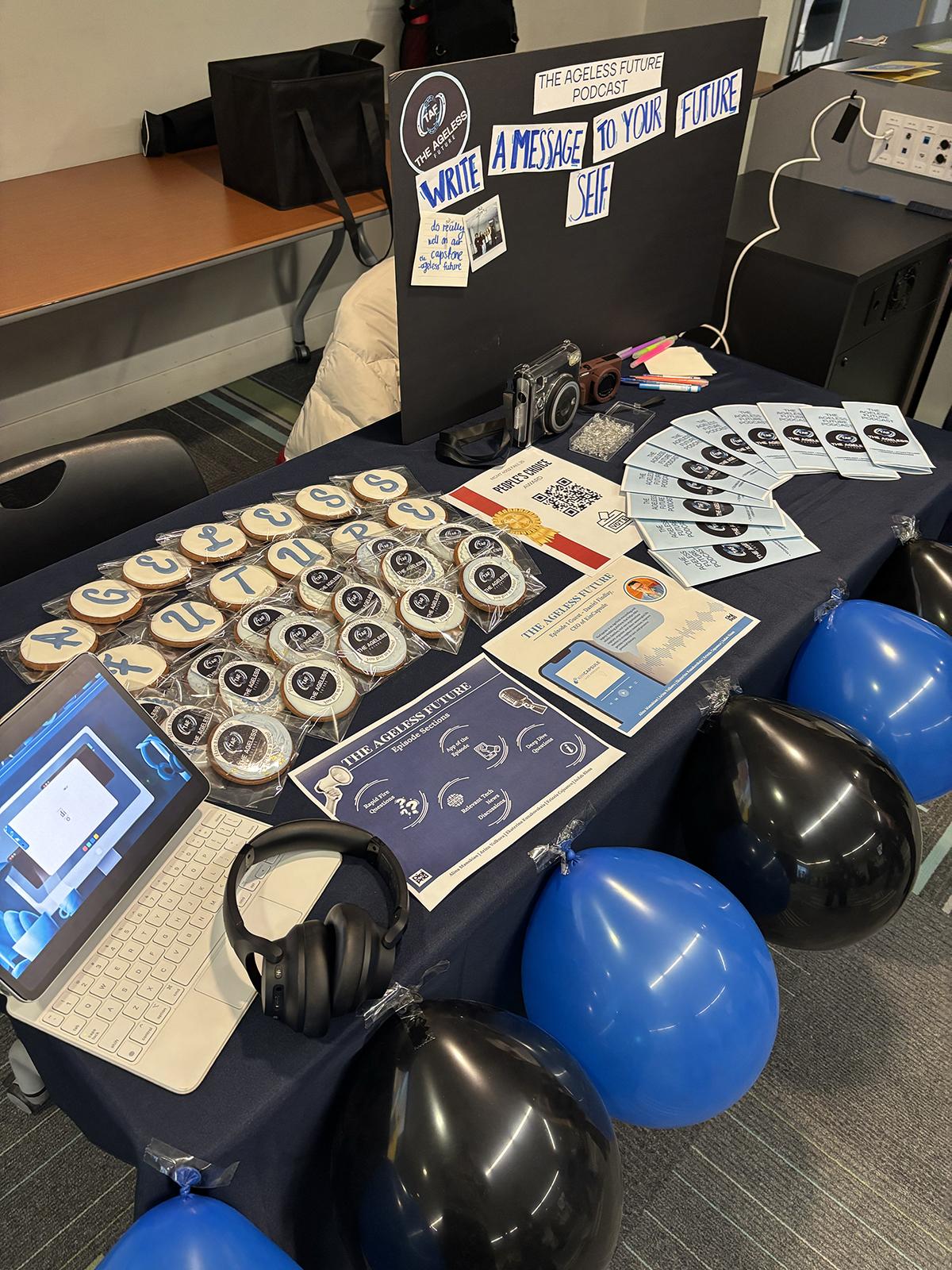 Balloons, buttons and literature are arranged on a table.