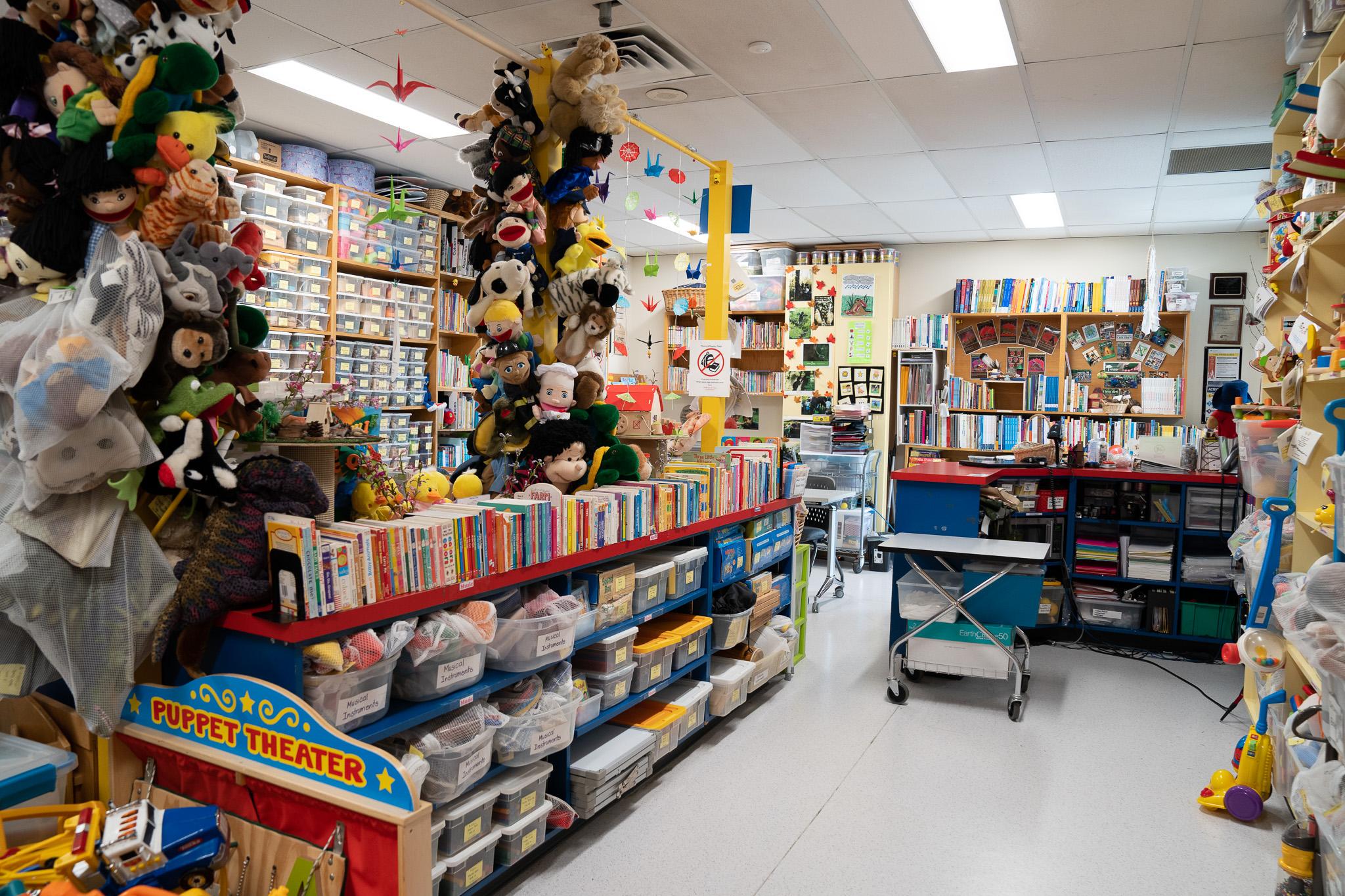 A room full of stuffed animals, children’s toys, books and arts and crafts supplies.