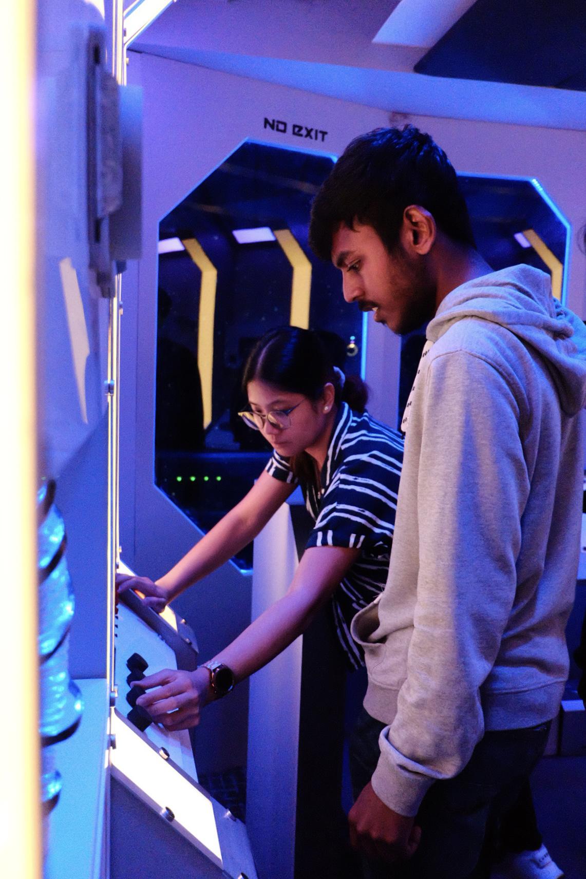 The Return to the Nebula Dawn is Humber Polytechnic’s spaceship-themed educational escape room. Michael Roz photo. Two people are trying to solve a puzzle in an escape room.