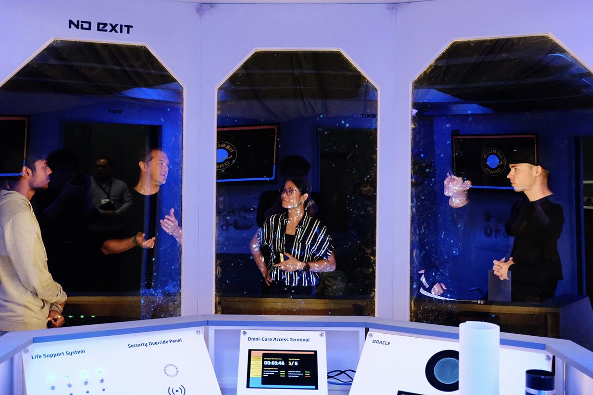 The Return to the Nebula Dawn is Humber Polytechnic’s spaceship-themed educational escape room. Michael Roz photo. A group of people are talking while inside a spaceship-themed escape room.