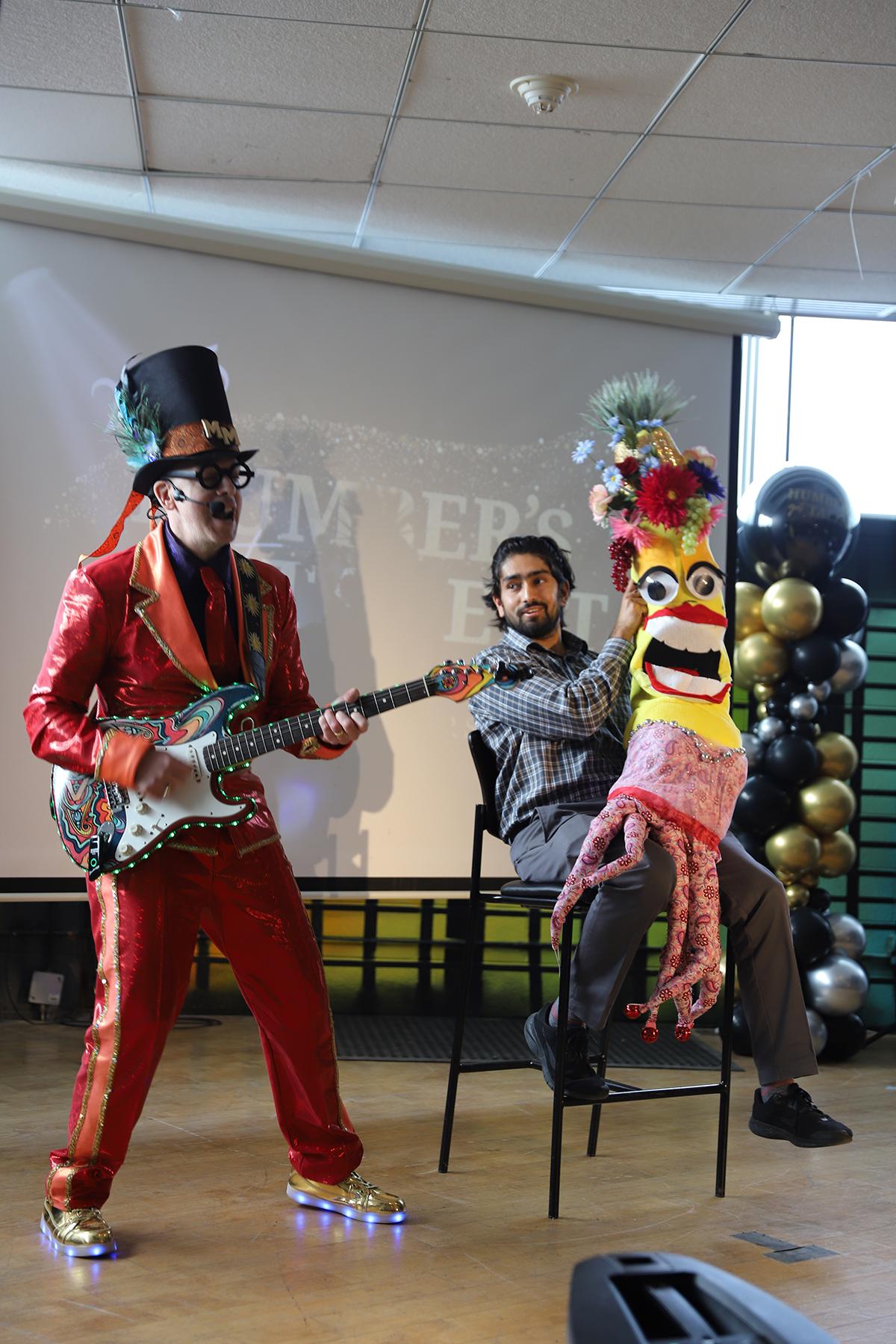 The Humber community raised more than $6,000 as part of the second annual Humber’s Got Talent event. A person wearing a bright costume plays a guitar as another holds a puppet.
