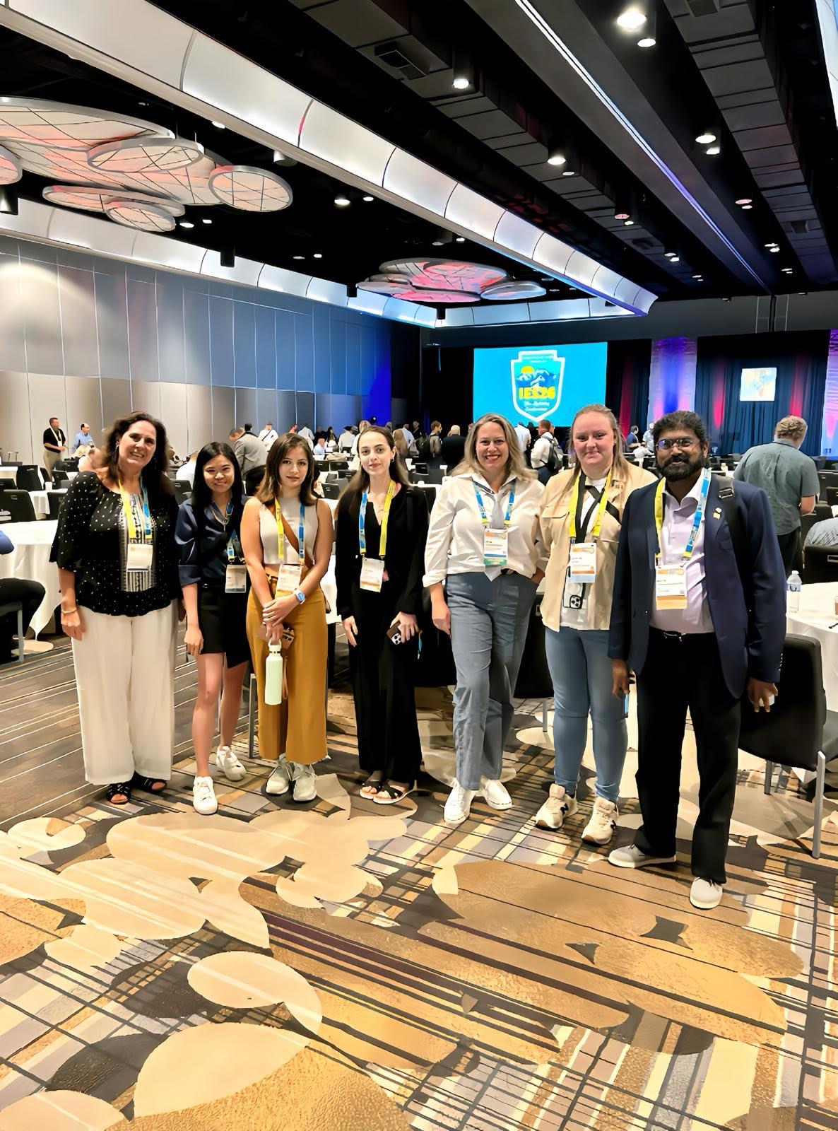 A group of people stand together at a conference.