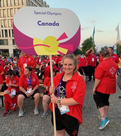 A person holds a sign that reads Special Olympics Canada.