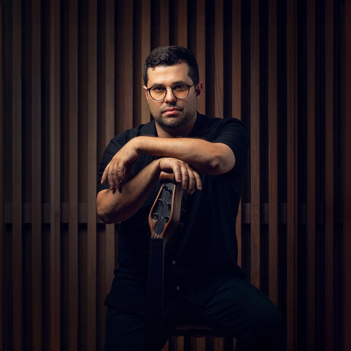 A person is standing while resting their arms on top of a music instrument.