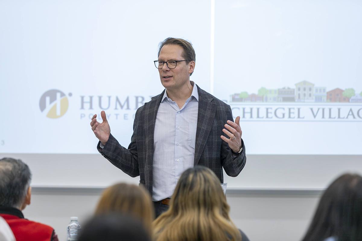 The Living Classroom at The Village of Humber Heights is a partnership between Humber’s Faculty of Health & Life Sciences and Schlegel Villages. A person is speaking to a room full of people.