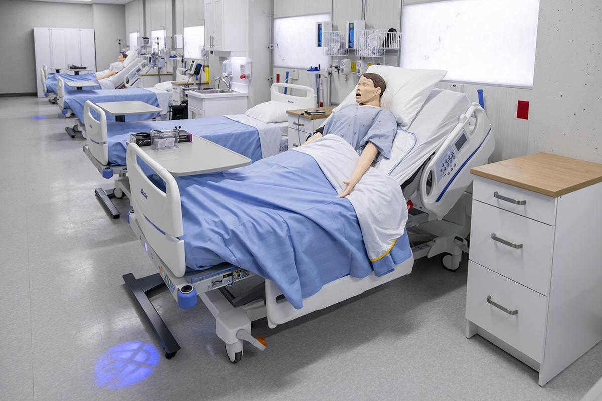 The Living Classroom at The Village of Humber Heights is a partnership between Humber’s Faculty of Health & Life Sciences and Schlegel Villages. A series of medical beds with training dummies lying on them.