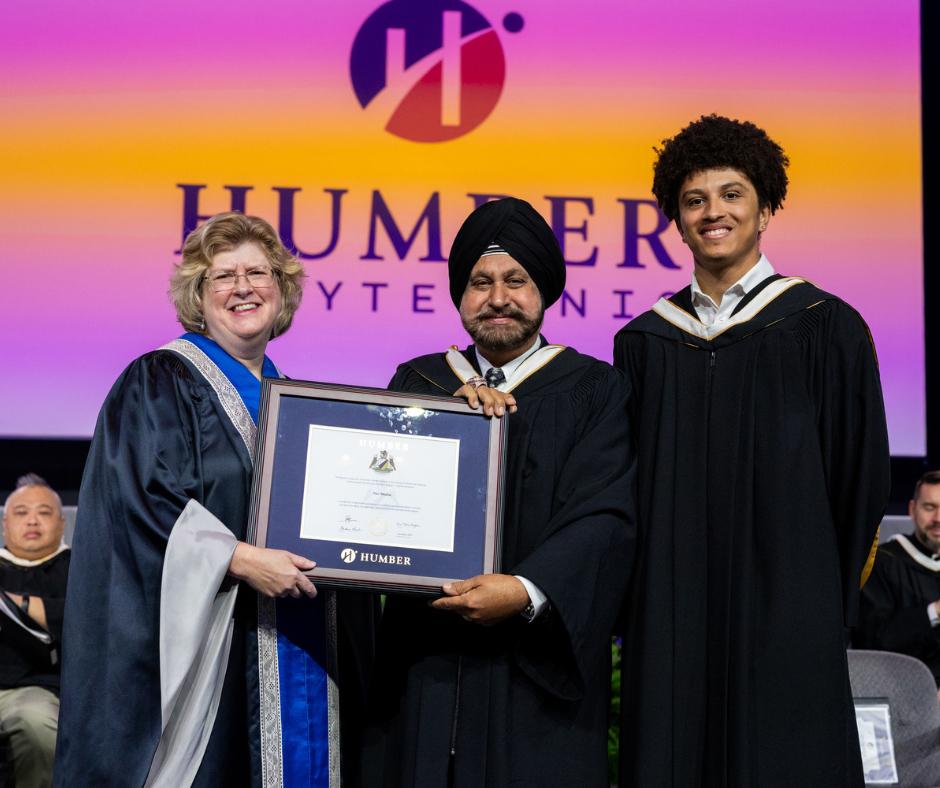 Humber Polytechnic conferred an honorary degree on entrepreneur and philanthropist Nav Bhatia during Fall 2025 Convocation ceremonies. Three people stand together on a stage. Two are holding the same honorary degree.