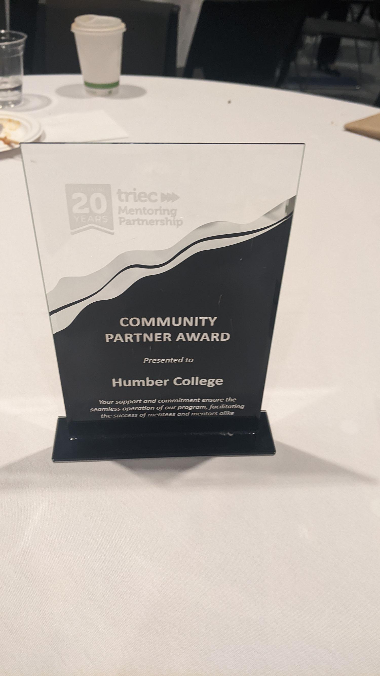 A trophy that reads Community Partner Award presented to Humber College.