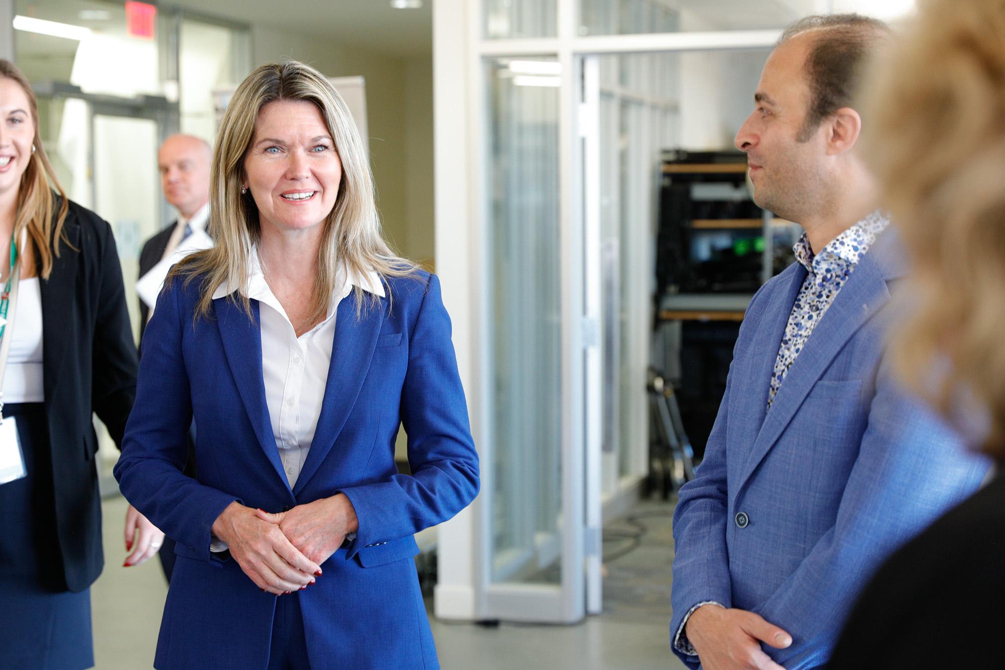 Ontario’s Minister of Colleges and Universities Jill Dunlop stands among a group of people.