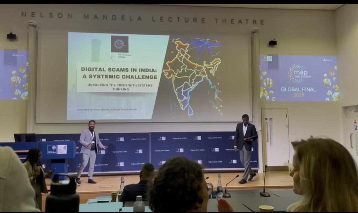 Graduate Aman Sharma participated in Map the System three times during his two years at Humber Polytechnic. Two people stand on stage and deliver a presentation to an audience.