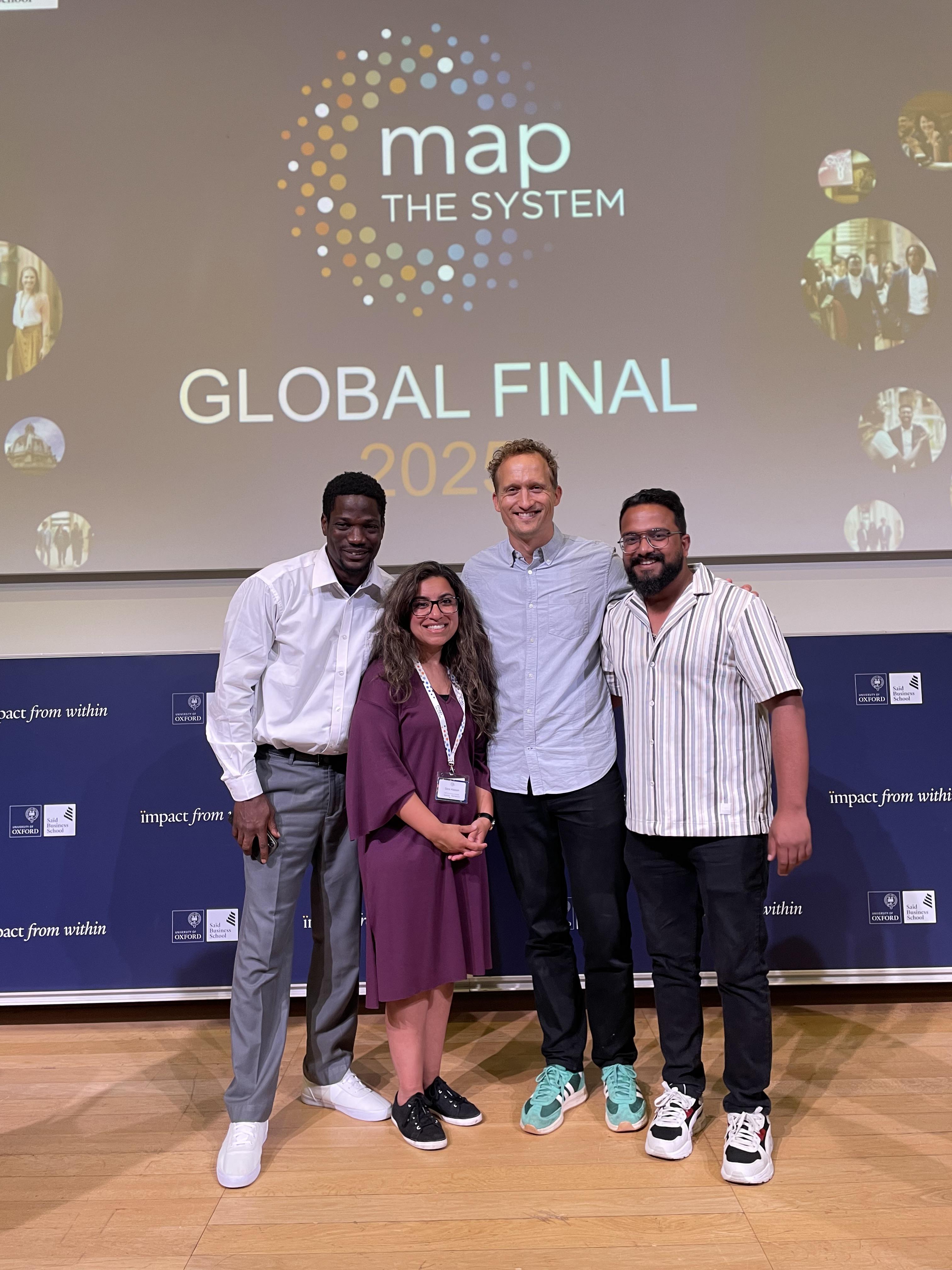 Graduate Aman Sharma participated in Map the System three times during his two years at Humber Polytechnic. Four people stand together on a stage.