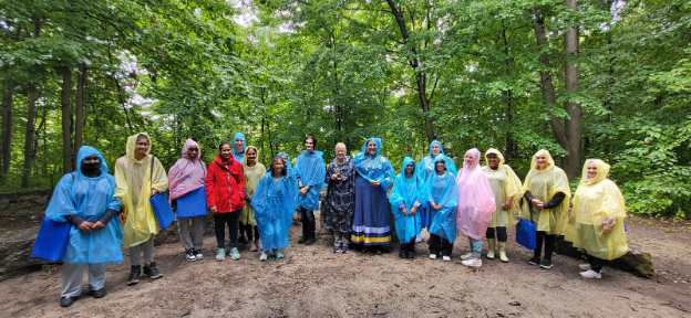 A group of people wearing multi-coloured rain jackets.