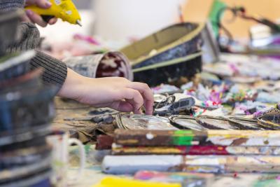A volunteer works with the artistic waste collected for the art installation. 