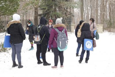 Students in the Two-Eyed Seeing ECE course listen to Lynn Short describe the rhododendron and its properties on a snowy trail