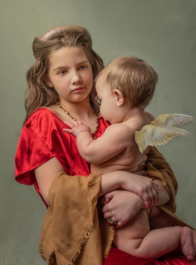 Digital art piece Catching Cupid, which shows a young girl holding a cherub in her arms.
