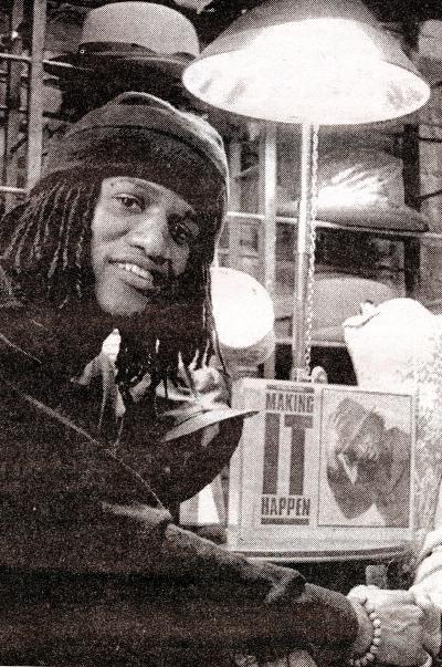 A smiling person next to an article and photo of themselves.