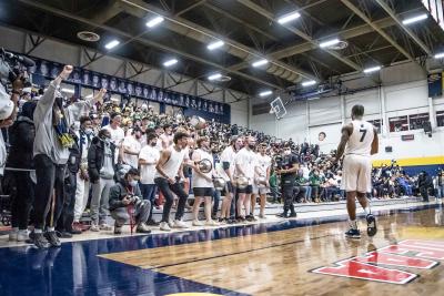 DeQuon Cascart stands in front of the crowd of Humber Hawks fans.