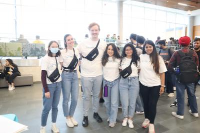 Several people pose for a photo wearing Take Back the Night t-shirts.