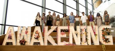A group of models stand behind a sign reading "Awakening" at the Humber College Fashion Show