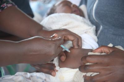 Two medical professionals tend to a newborn baby. 