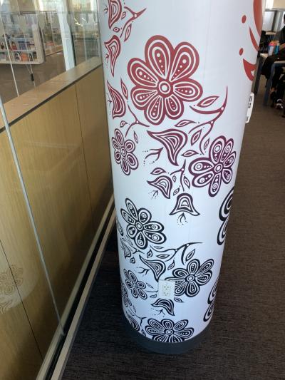 A series of designs inspired by artist Partick Hunter’s Indigenous heritage on a white pillar.