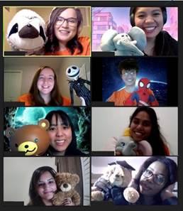 A computer screen is split into eight, showing eight students on a Zoom call, each holding stuffed animals.