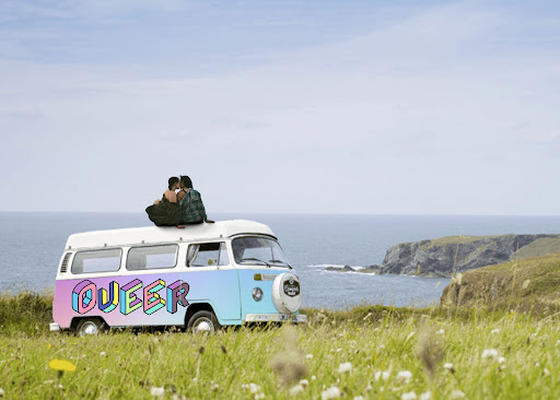 Couple sitting on the roof of a VW Camper overlooking the ocean