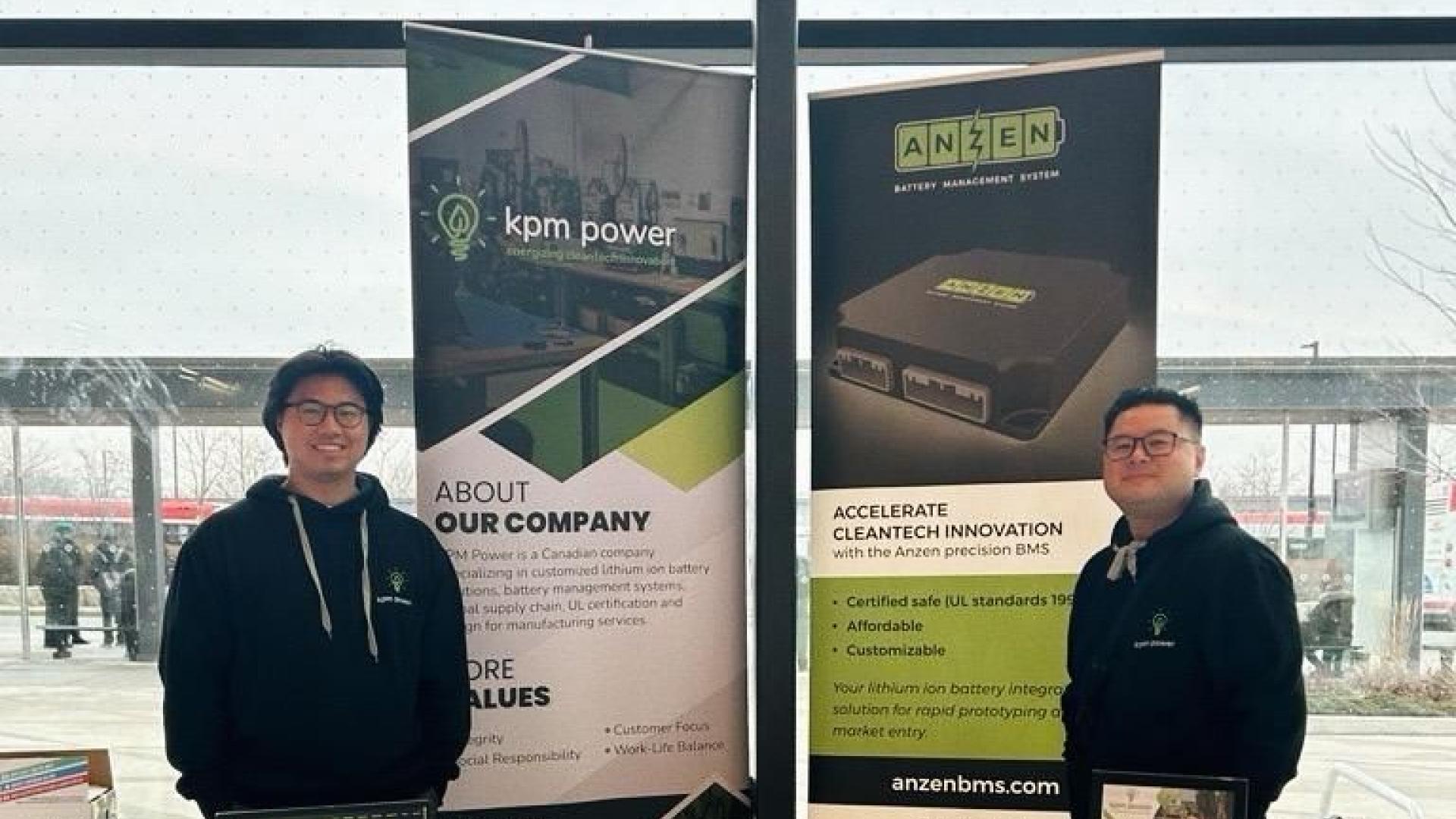 Chang Duong and Allan Dayrit stand smiling at the KPM Power booth in front of a window at Humber's North Campus for the January for the W24 Humber FAST Co-op Engineering Event.